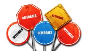 Colorful road signs labeled "Referrals," emphasizing referral concepts.