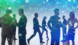 Silhouettes of people networking with a digital data network overlay.