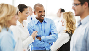 Group of professionals engaged in a conversation at a networking event.