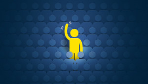 Yellow figure raising a hand, standing out from a crowd on a dark blue background.