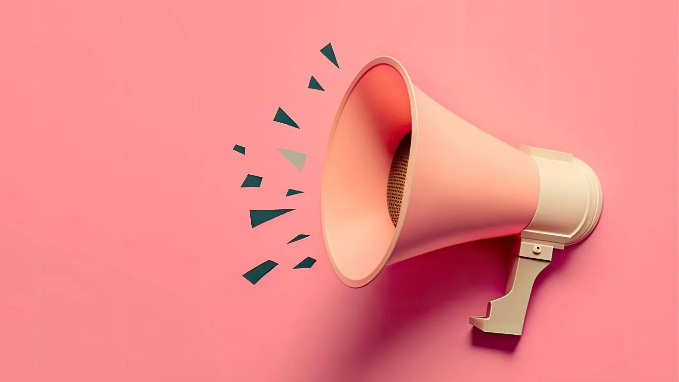 Pink megaphone on a pink background, illustrating a message announcement.